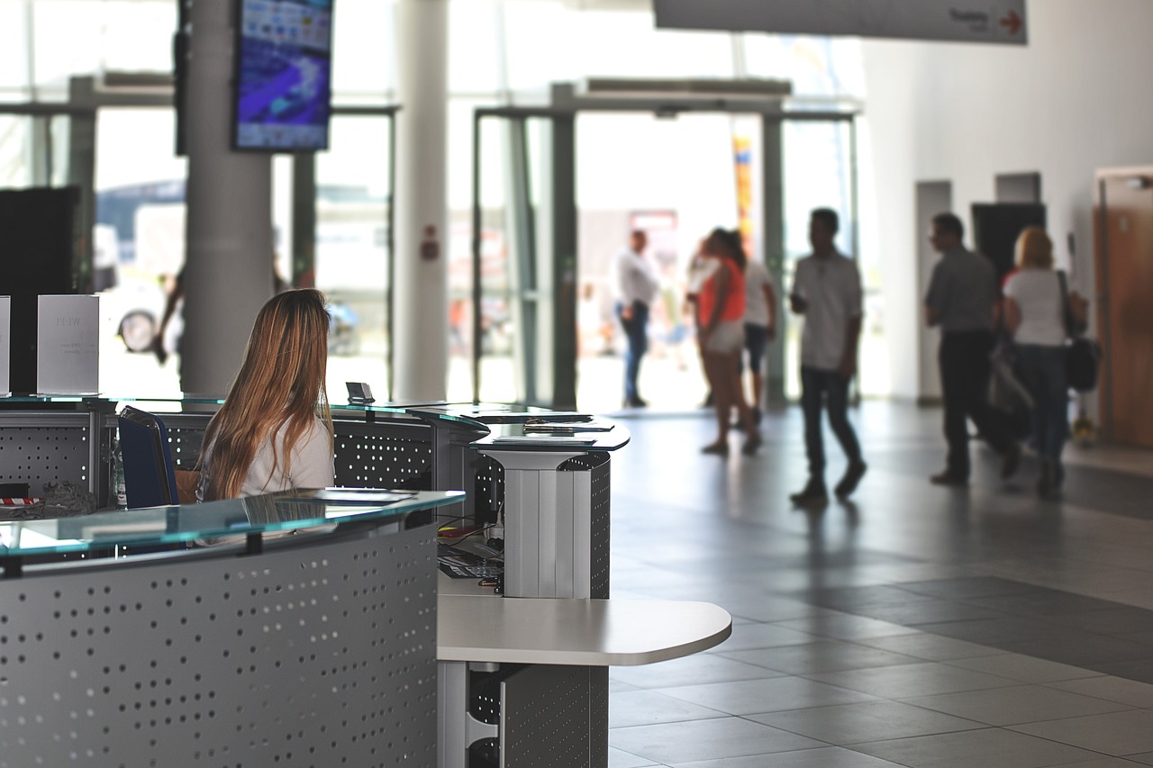 A female sitting in a reception of a modern looking museum.